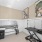 Pet spa with a bet wash station, grooming table, and dog artwork on the walls.